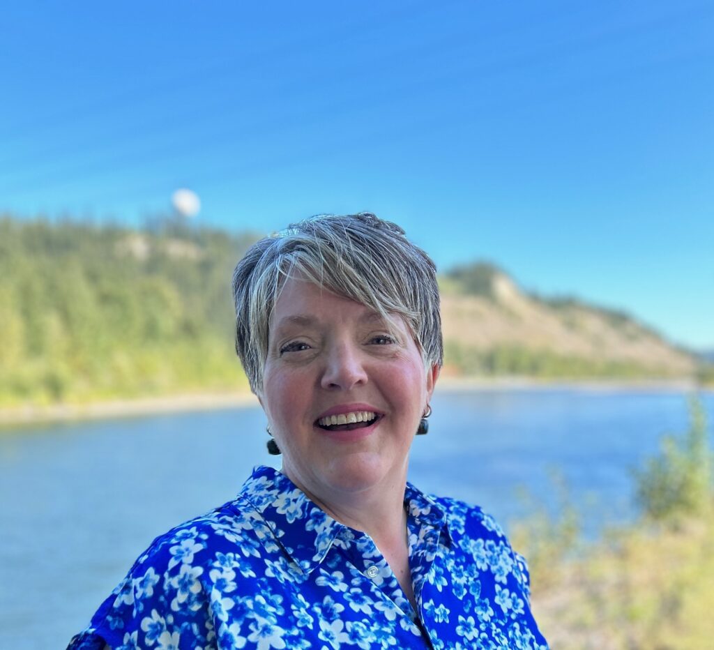 Dawn Bast. AT the river. Laughing.